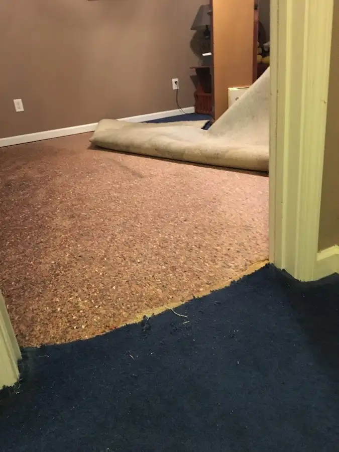 Carpet pad removal revealing water damage during Water Mitigation Services in Waimalu